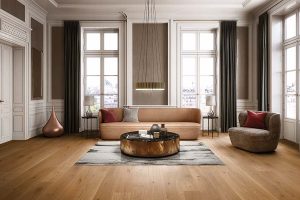 Wood flooring in a grand living room with big windows